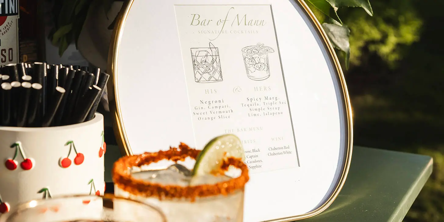Bar of Mann cocktail setup with elegant signage and custom drinkware