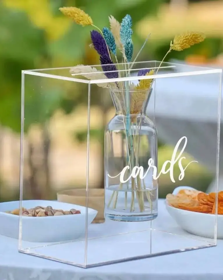 Modern clear acrylic card box that lets guests see the growing collection of cards and envelopes inside. The transparent design creates a contemporary aesthetic and coordinates with our acrylic signage collection. Secure lid protects contents.