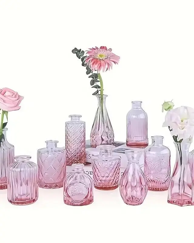 A box of 12 mini pink glass bud vases for single-stem floral displays. The soft blush tone adds romantic warmth to tablescapes and pairs perfectly with our pink glass candle holders. Ideal for spring weddings, bridal showers, and garden parties.