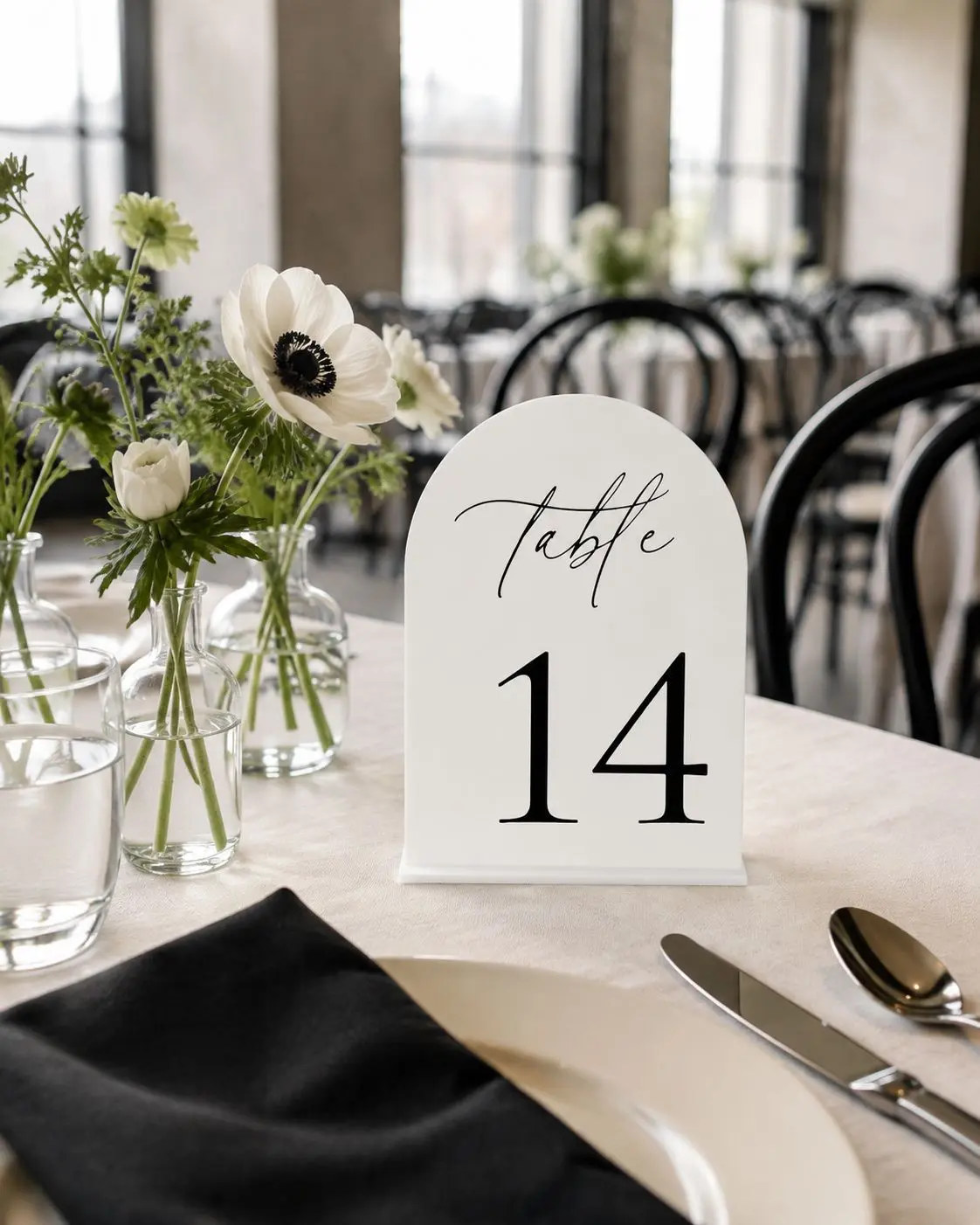 Elegant white acrylic table numbers featuring a flowing cursive design. Their crisp, neutral finish complements modern, romantic, and minimalist tablescapes while helping guests easily find their seats.