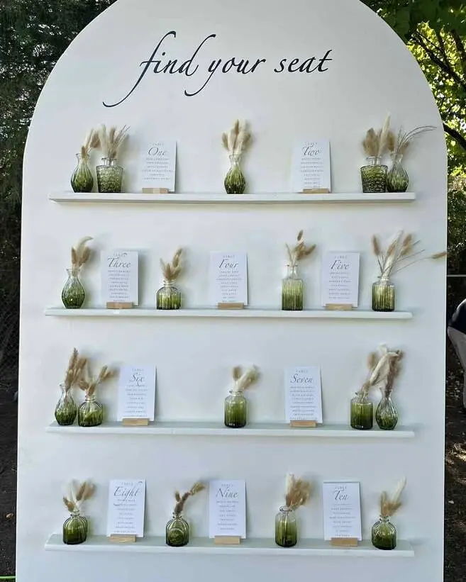 Versatile 8-foot white display wall featuring 4 built-in shelves. Perfect for escort card displays, seating charts, dessert tables, welcome areas, favour stations, and styled décor displays. Its clean, modern design works beautifully with any colour palette and creates an elegant focal point for weddings, showers, and special events. Freestanding and suitable for a variety of venue types.